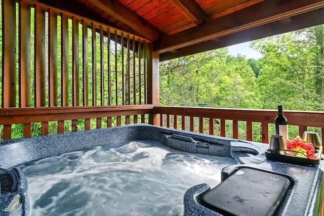 wooden deck featuring a hot tub