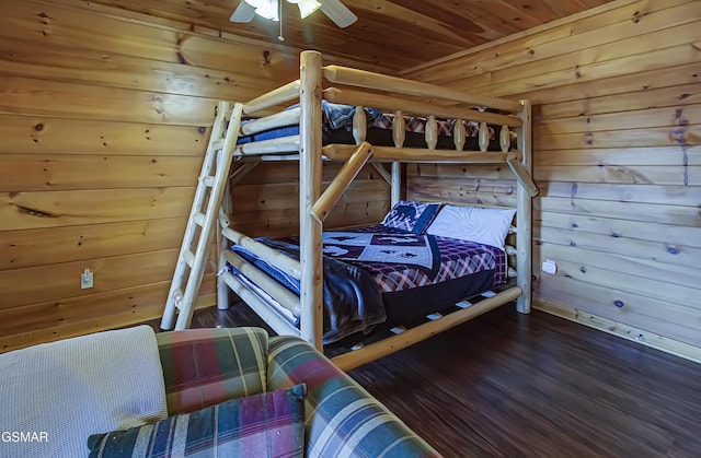 bedroom featuring wooden walls, ceiling fan, and wood ceiling