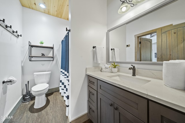 bathroom with vanity, wood finished floors, baseboards, wooden ceiling, and toilet