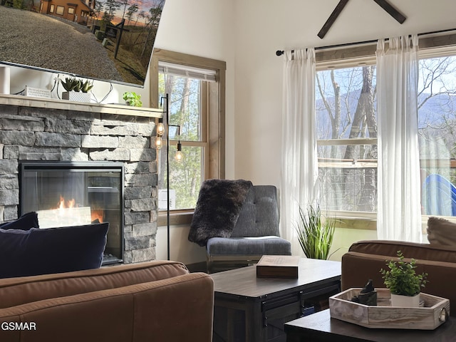 living room featuring a stone fireplace