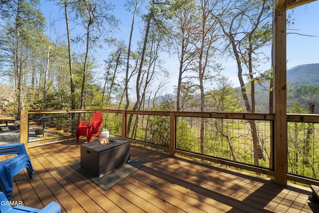 deck featuring a fire pit and a mountain view