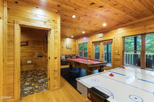 rec room with wood walls, french doors, wood ceiling, and light wood-type flooring