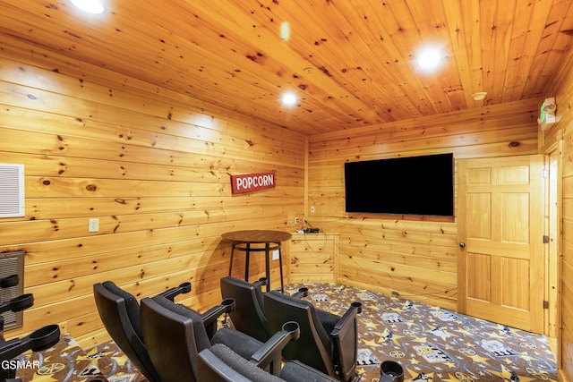 home theater room with wood walls