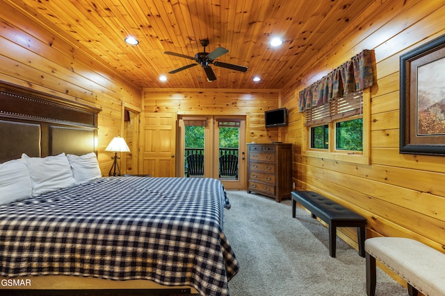 bedroom featuring wood walls, wood ceiling, light carpet, and access to outside