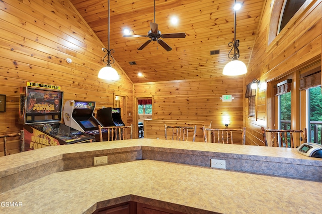 kitchen with ceiling fan, wooden ceiling, hanging light fixtures, high vaulted ceiling, and wooden walls