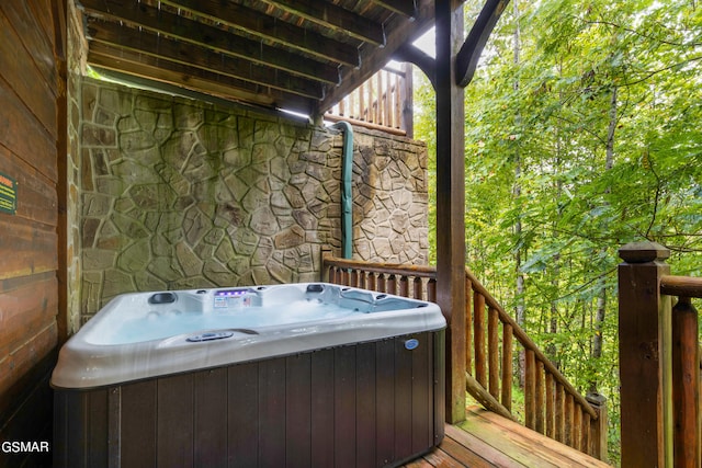 wooden deck featuring a hot tub