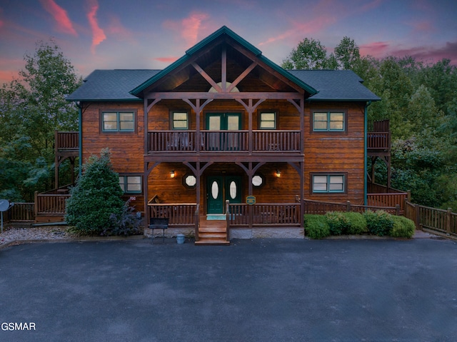 view of front of property with a balcony and covered porch