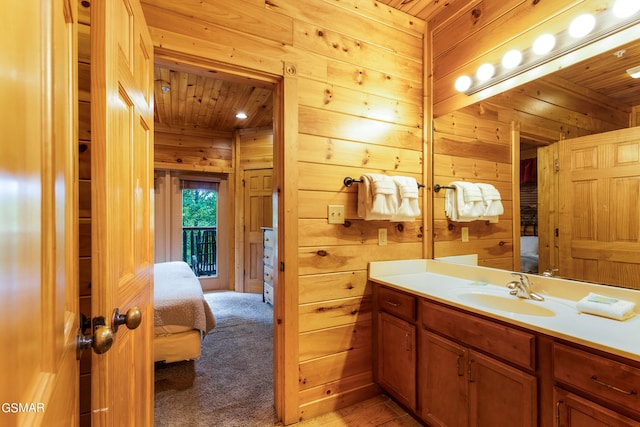 bathroom with vanity, wooden ceiling, and wooden walls