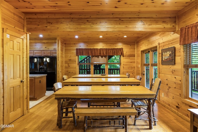 dining space featuring light hardwood / wood-style flooring, plenty of natural light, wooden walls, and wood ceiling