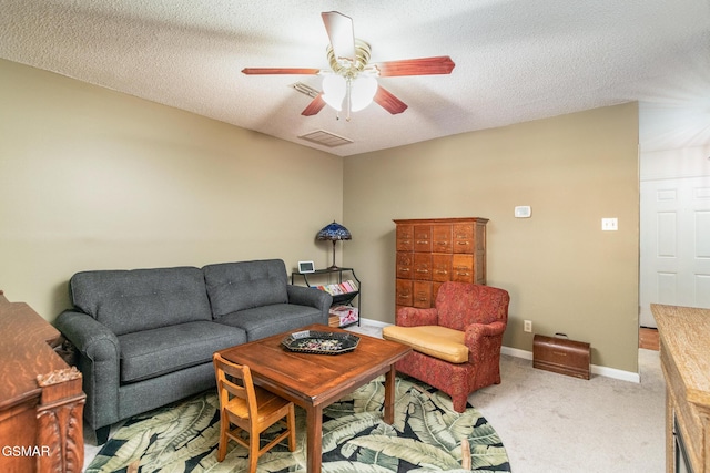 living area with visible vents, baseboards, a ceiling fan, a textured ceiling, and carpet flooring