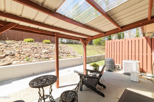 view of patio with fence and central AC unit