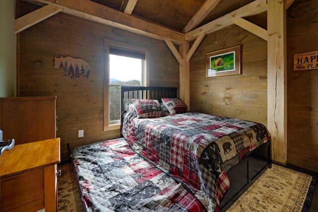 bedroom featuring wood walls and vaulted ceiling