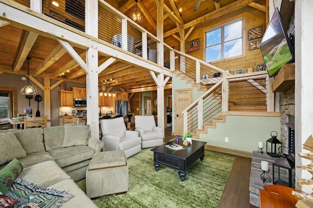 living room with high vaulted ceiling, hardwood / wood-style floors, and wood ceiling