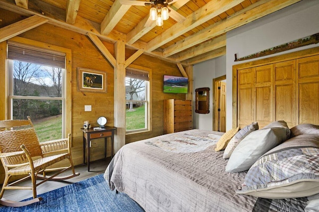 bedroom with hardwood / wood-style floors, wooden ceiling, wood walls, ceiling fan, and beam ceiling