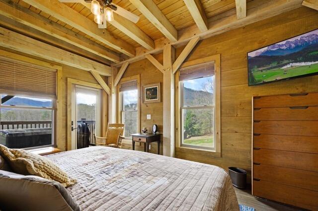 bedroom with wooden ceiling, ceiling fan, wooden walls, hardwood / wood-style flooring, and beam ceiling