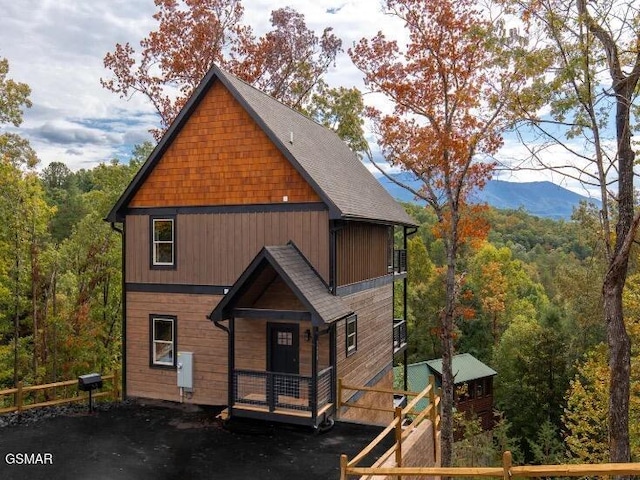 2434 Breezy Rd, Sevierville, TN 37876 - view of front facade featuring a wooded view, roof with shingles, a mountain view, and covered porch