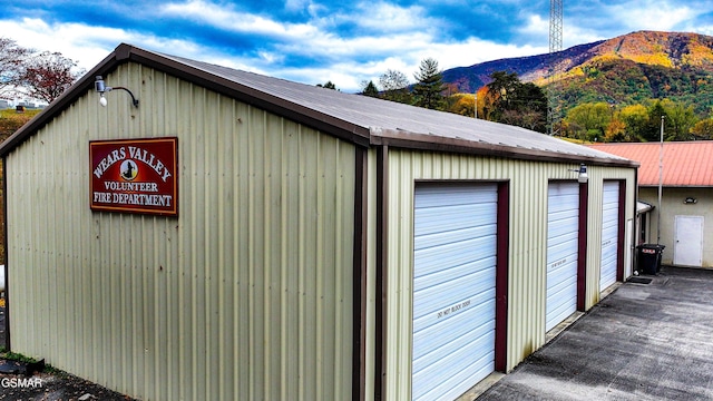 view of outbuilding with a garage and a mountain view