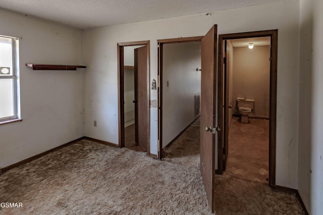 interior space featuring light colored carpet and a textured ceiling