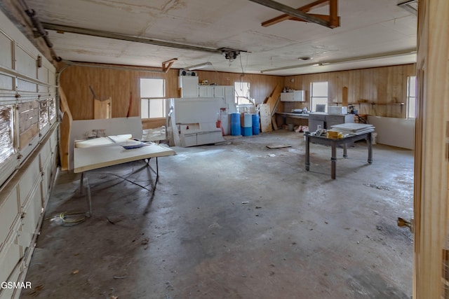 misc room with concrete floors and wood walls