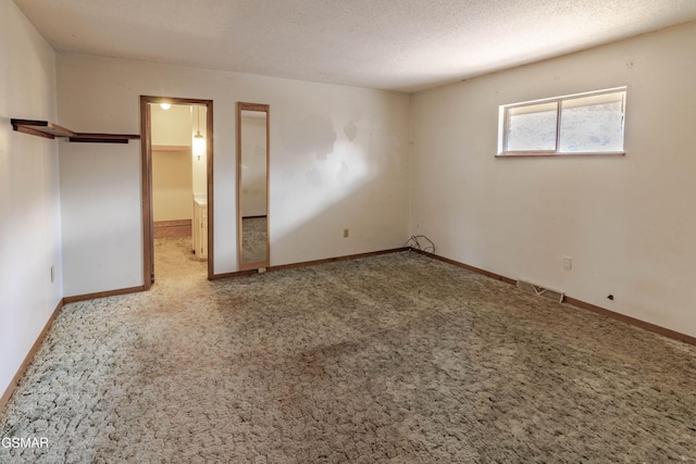 unfurnished bedroom featuring carpet and a textured ceiling