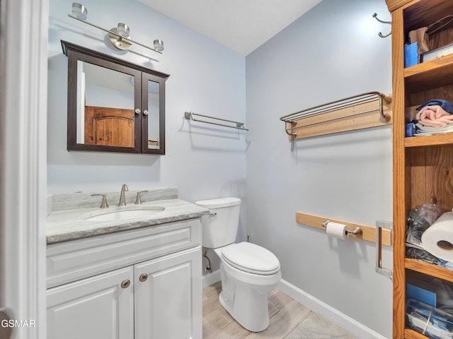 730 Deerfoot Dr, Gatlinburg, TN 37738 - bathroom with toilet, vanity, baseboards, and wood finished floors