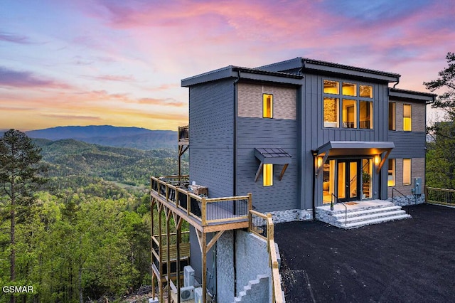 back of house with board and batten siding and a mountain view