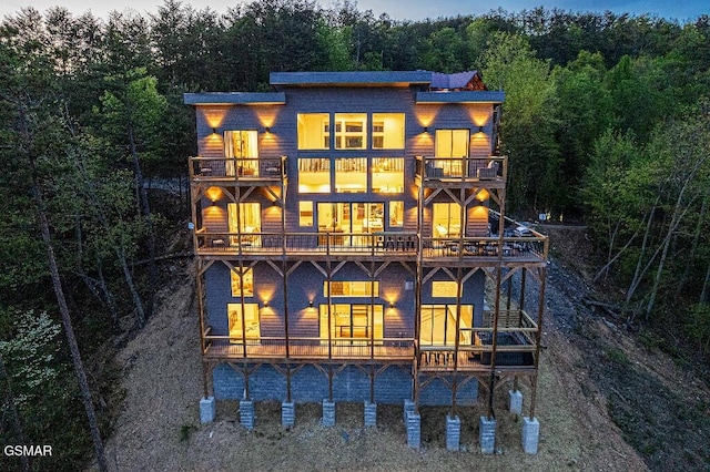 937 Autumn Ridge Way, Sevierville, TN 37876 - rear view of house with a balcony and a wooded view