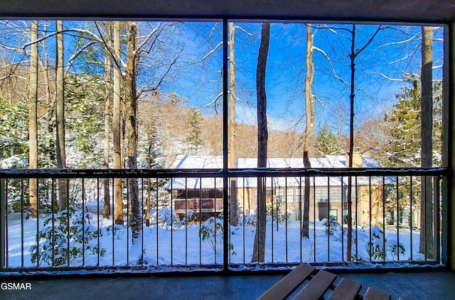 view of snow covered back of property