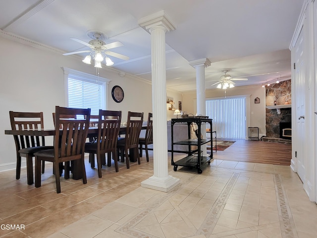 dining room featuring light tile patterned floors, ornamental molding, and decorative columns