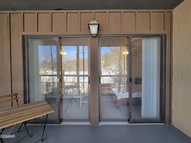 doorway to outside with a healthy amount of sunlight and wood walls