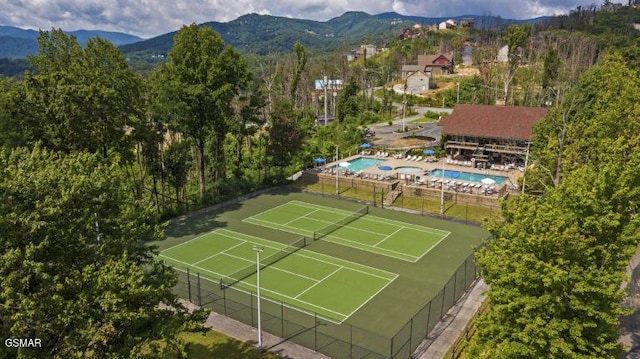 view of tennis court featuring a mountain view