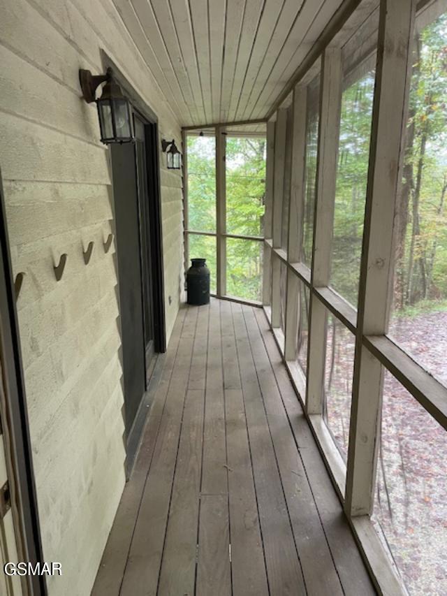 unfurnished sunroom featuring wooden ceiling