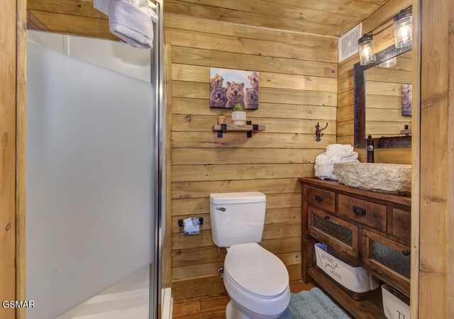 125 Cricket Hollow Way, Cosby, TN 37722 - bathroom featuring a shower stall, wooden walls, toilet, and vanity