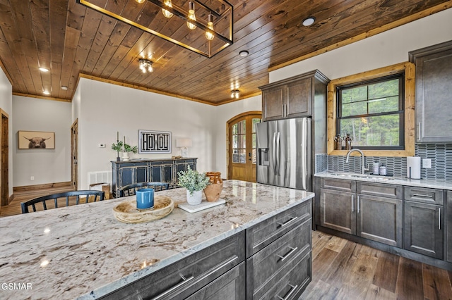 kitchen with dark wood-type flooring, sink, stainless steel refrigerator with ice dispenser, dark brown cabinets, and wood ceiling