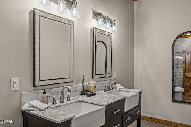 bathroom with tile patterned floors and vanity