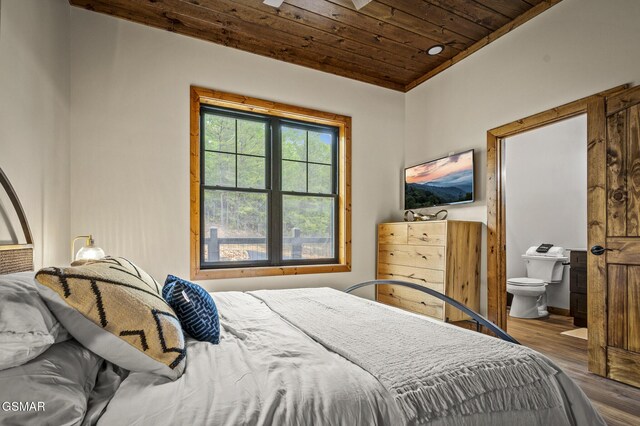 bedroom with wood-type flooring, wood ceiling, and ensuite bath