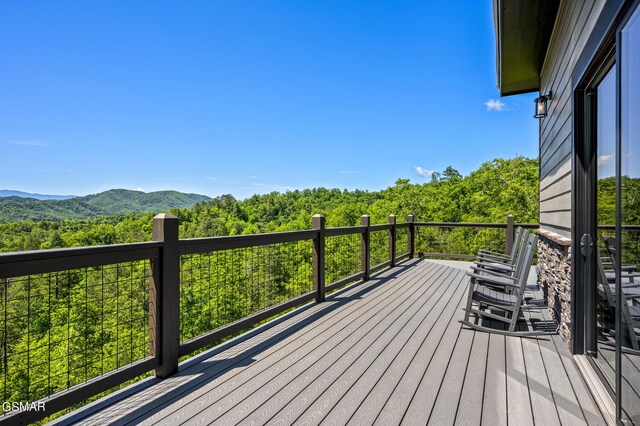 wooden deck with a mountain view