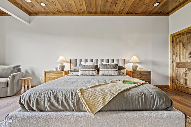 bedroom featuring hardwood / wood-style flooring and wood ceiling