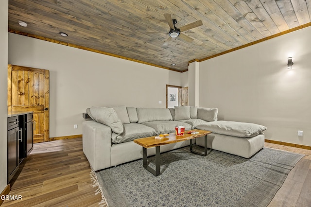 living room with hardwood / wood-style flooring, ceiling fan, wooden ceiling, and ornamental molding