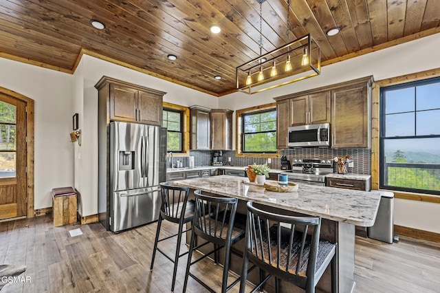 kitchen featuring a center island, light stone countertops, wooden ceiling, and appliances with stainless steel finishes