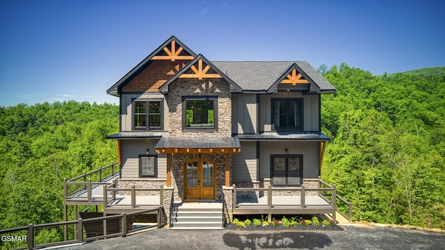 view of front facade with covered porch and french doors