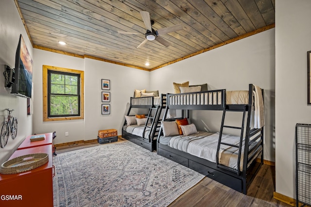 bedroom with ornamental molding, dark hardwood / wood-style flooring, ceiling fan, and wooden ceiling