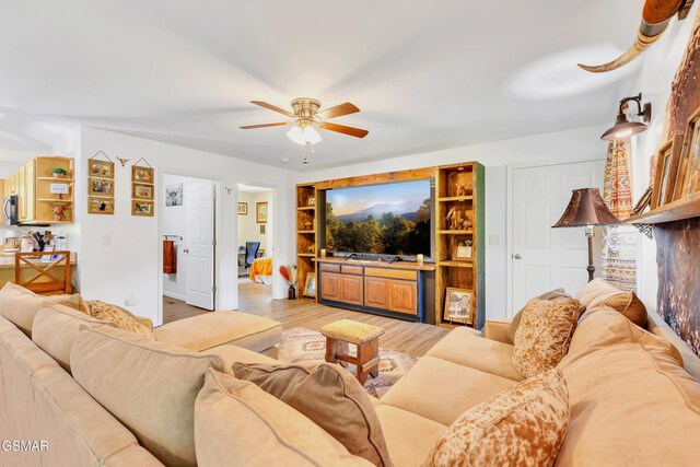 1668 Goodwater Rd, Bybee, TN 37713 - living room featuring a ceiling fan, light wood finished floors, and baseboards