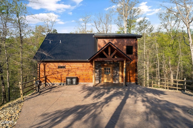 2311 Wild Heron Way, Sevierville, TN 37862 - chalet / cabin with metal roof, a view of trees, and stone siding