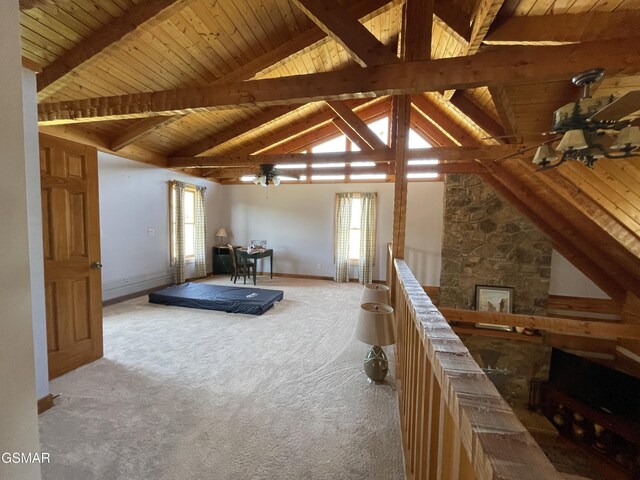 interior space featuring light carpet, lofted ceiling with beams, wood ceiling, and a healthy amount of sunlight
