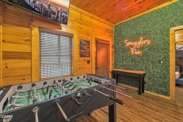 game room featuring wood ceiling, wooden walls, and hardwood / wood-style floors