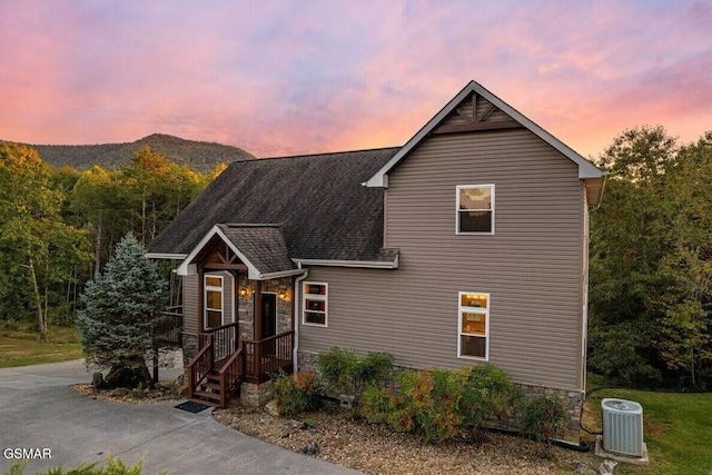 view of front facade with a mountain view and central AC unit