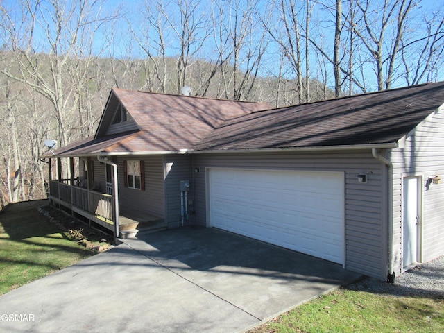 view of side of property with a porch and a garage