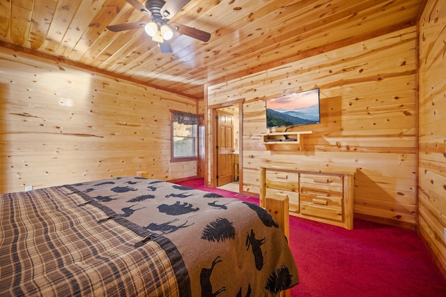 bedroom with ceiling fan, wooden walls, carpet floors, and wood ceiling