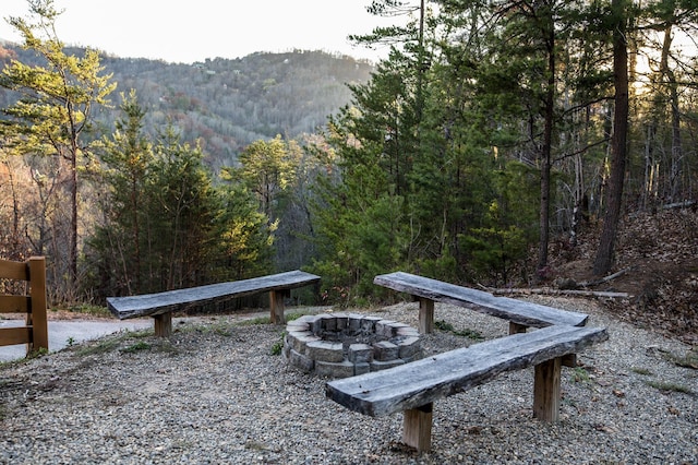 exterior space featuring a mountain view and an outdoor fire pit